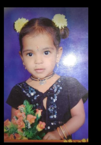 Saivani childhood portrait holding flowers